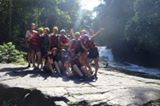 Group of river rafters with waterfall backround