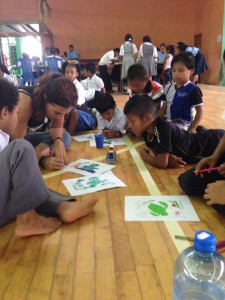 Foreign girl drawing with indigenous children