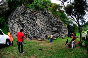 People standing next to the rock where the will climb