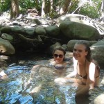 Three girls soaking in natural hot springs