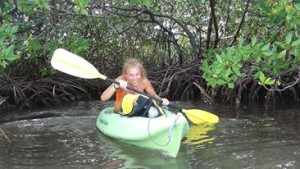 Happy girl in a green kayak