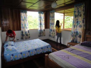Two women arranging room in Hostel Turrialba