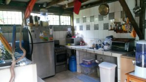 Kitchen with fridge, pots, water filter, stove