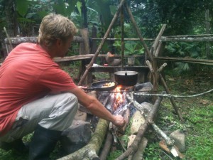 Guy making food on open fire