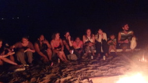 Group of students around a beach bonfire