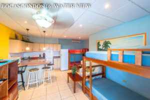 Kitchen, dining area and bunk beds in bright blue colors