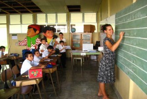 Foreign girl writing on a blackboard in Costa Rican Classroom