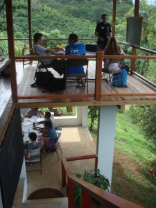 Two story open air classrooms with students studying